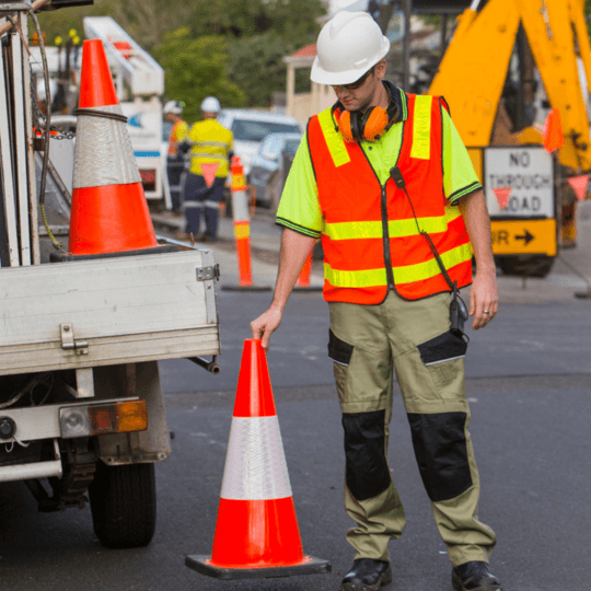 person standing next to a cone